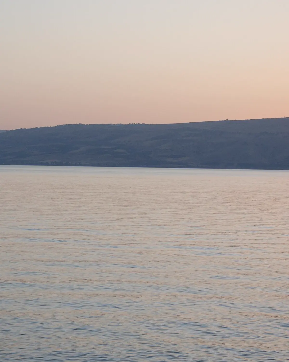 The Sea of Galilee at sunset, with the hills of the eastern shore beyond